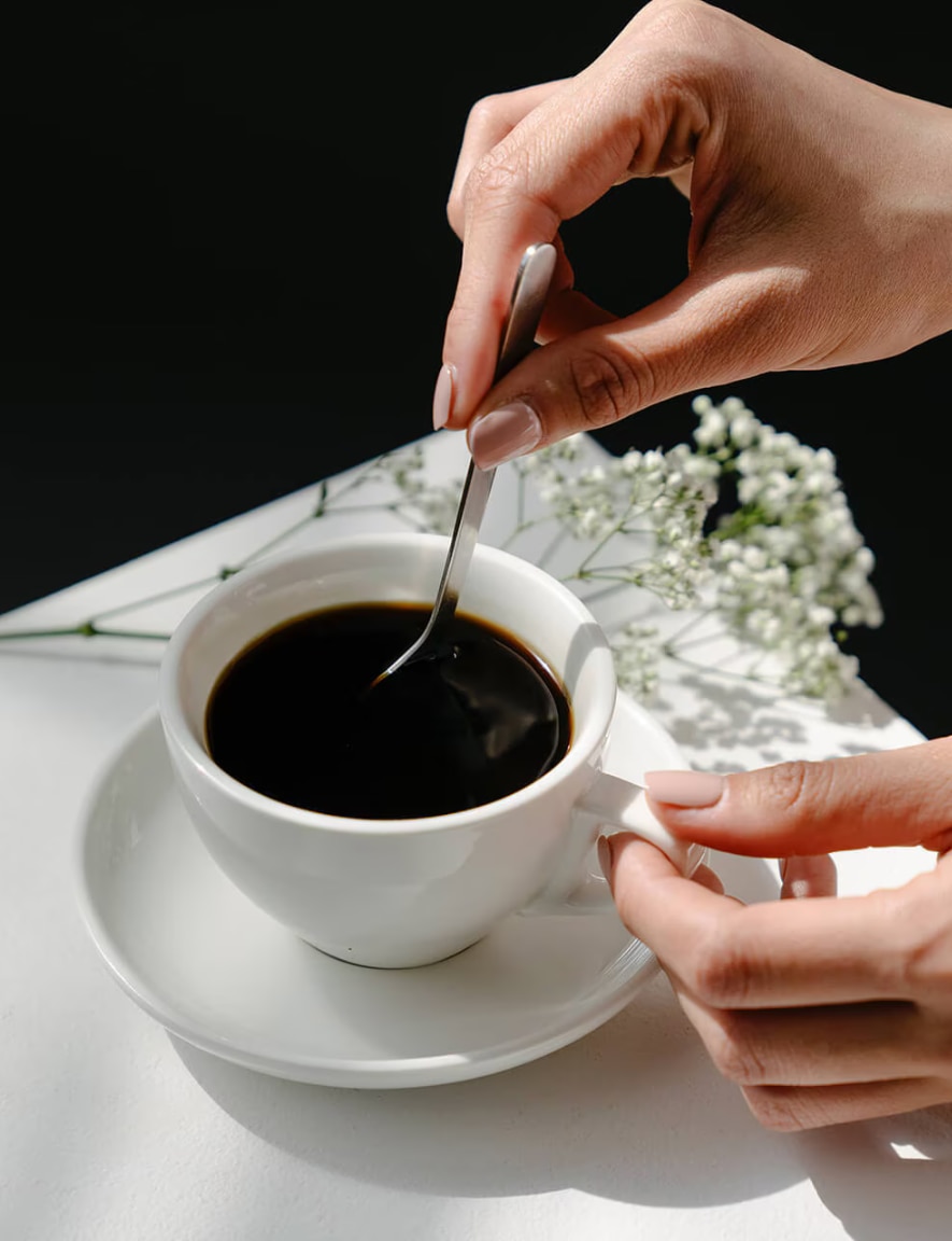 A woman enjoying an Espresso in an outside café