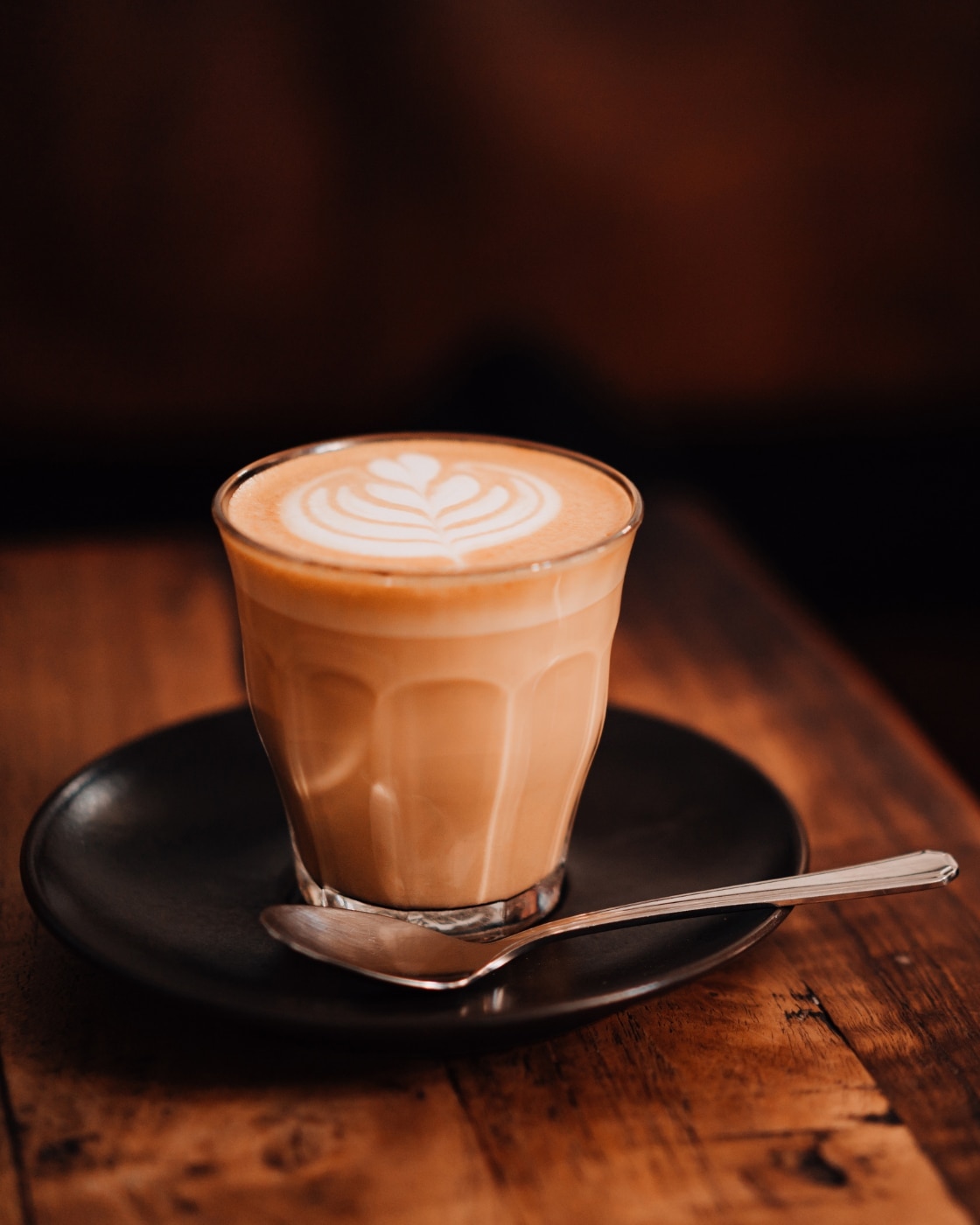 Hands holding cup of black coffee