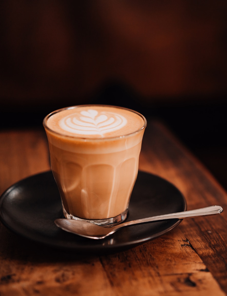 a glass of flat white on a tray