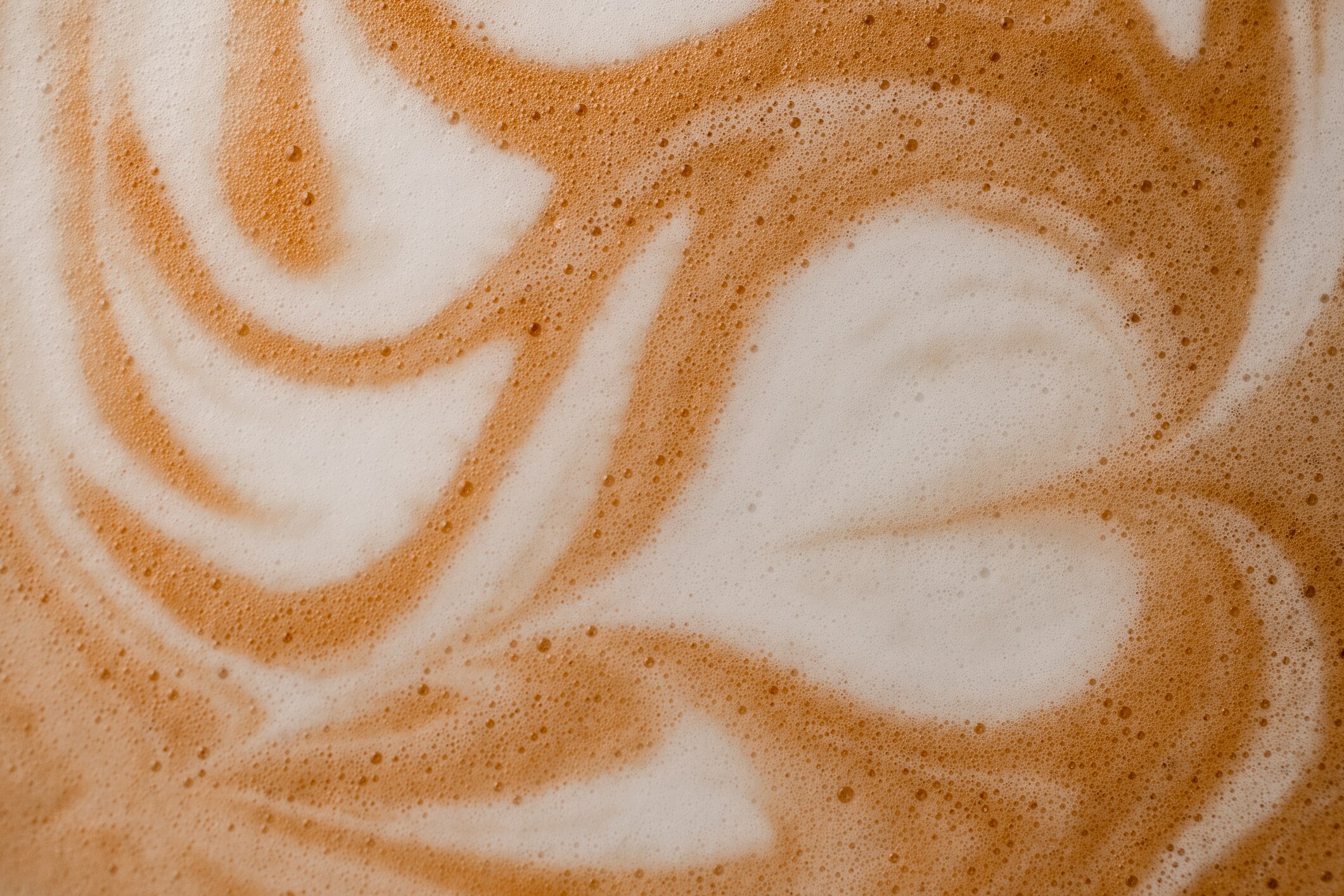 Close-up of the inside of a cup of mocha with a heart shaped froth