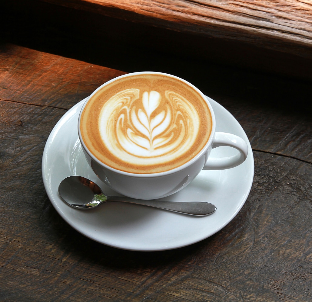 A latte with whipped cream and chocolate on top